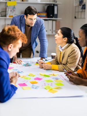 Project managers and employees brainstorming on ideas - Multi-ethnic group of workers having business meeting in a start-up office